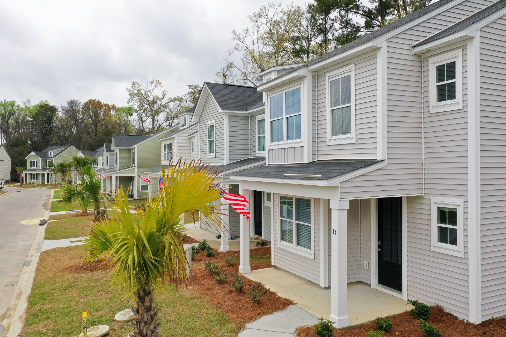 Ground-level view of VictoryBase Properties townhomes with modern architecture and landscaping